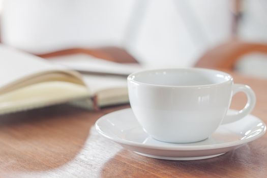 White coffee cup with notebook, stock photo