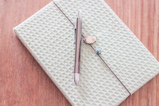 Green cover notebook with pen, stock photo