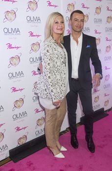 LAS VEGAS, - APRIL 11: Entertainer Olivia Newton-John (L) and actress Joey Lawrence attends the grand opening of her residency show 'Summer Nights' at Flamingo Las Vegas on April 11, 2014