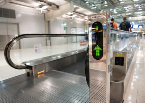 airport escalator with unrecognizable people walking on