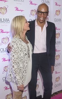 LAS VEGAS - APRIL 11: Entertainer Olivia Newton-John (L) and television personality RuPaul attends the grand opening of her residency show 'Summer Nights' at Flamingo Las Vegas on April 11, 2014 