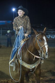 LOGANDALE , NEVADA - APRIL 10 : Cowboy Participating in a Calf roping Competition at the Clark County Fair and Rodeo a Professional Rodeo held in Logandale Nevada , USA on April 10 2014