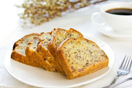 Homemade Banana cake by a cup of cofee