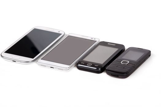 collection of cell phones, old design and new smart phones isolated on white