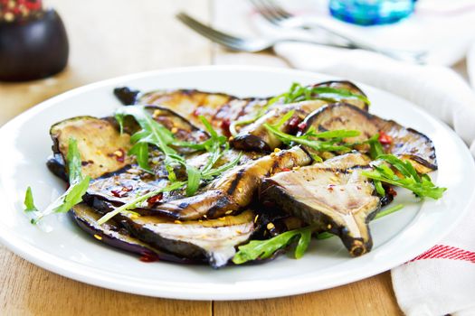 Grilled Aubergine salad with dried chili flake and Rocket