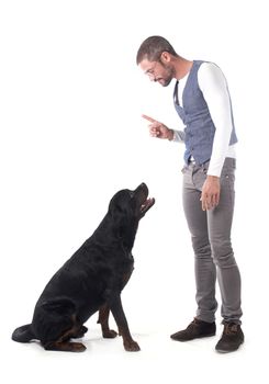 man and rottweiler in front of white background