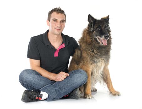 old belgian shepherd and man in front of white background