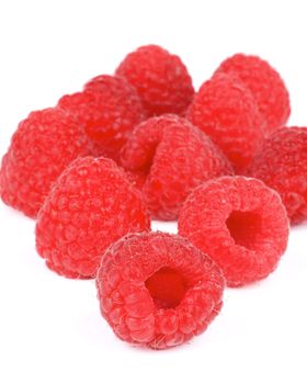 Heap of Perfect Ripe Raspberries with Water Drops isolated on white background. Focus on Foreground