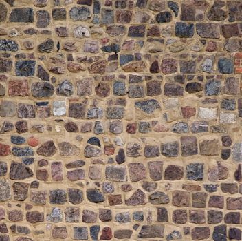 Background of Multicolored Old Damaged Bricks with Concrete Smoothing closeup