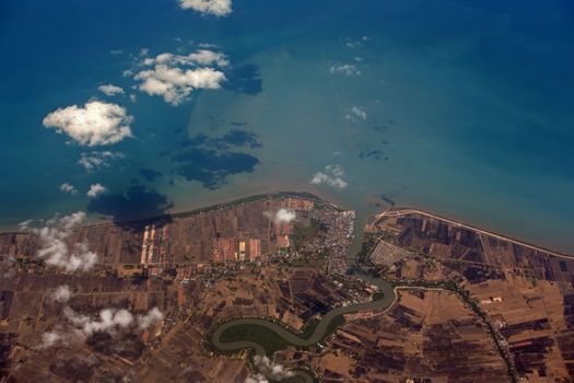 Indonesia, Bali. Coastline is visible through clouds. Aerial view