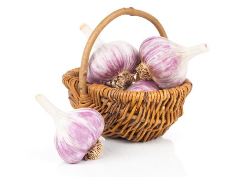Garlic in a wicker basket, isolated on white background
