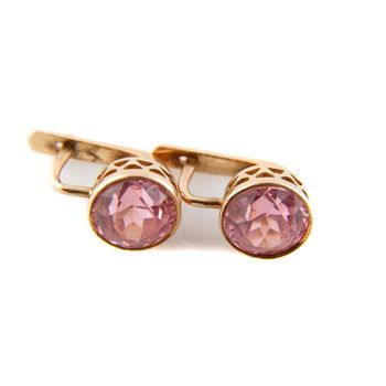 Vintage rose gold earrings with big stone on white background