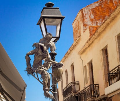 Lamp on the street with original ornament in ancient part of the city of Retimno, the island of Crete.