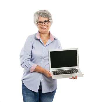 Happy elderly woman holding and showing something on a laptop