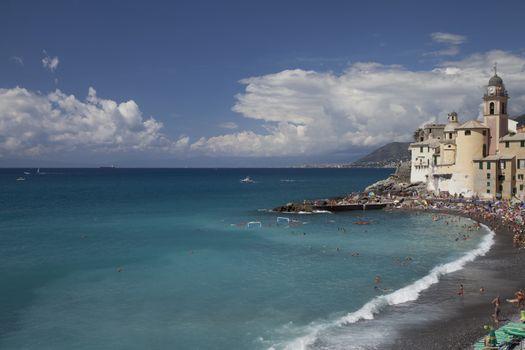 Wonderful blue sea and beach with many defocused people