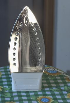 Plate of the iron over ironing board