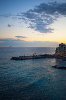 Long pier on the sea, at sunset light