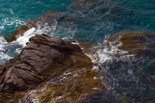 Rocks on the coast with deep blue sea on the back, horizontal image