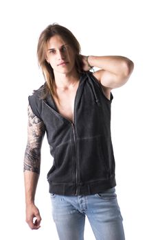 Beautiful young long haired man in jacket posing isolated on white