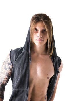 Beautiful young long haired man in hoodie jacket open on naked chest, posing isolated on white