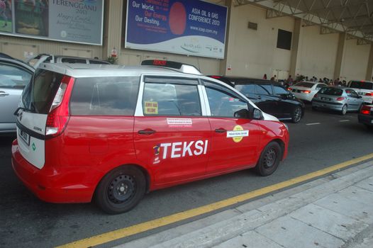 KLCCT, Malaysia - June 7, 2013: Red colored taxi that operated in Kuala Lumpur Low Cost Carrier Terminal (KLCCT), Malaysia.