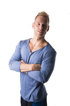 Fit male model posing with a lot of confidence, arms crossed on his chest, isolated on white