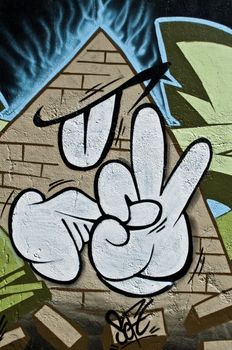 Mulhouse - France - 17 August 2014 - Urban Art - abstract pyramid and hand gesture