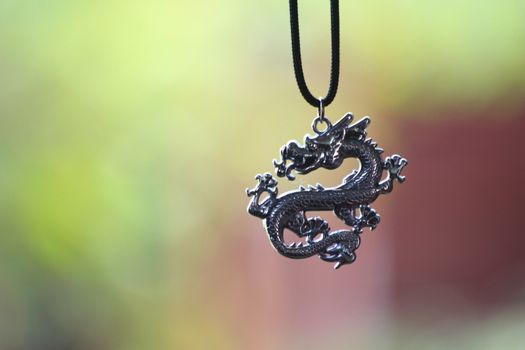 The locket in shape of dragon is hanging.