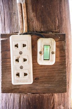 Electrical switch and plug box installed on wooden pole