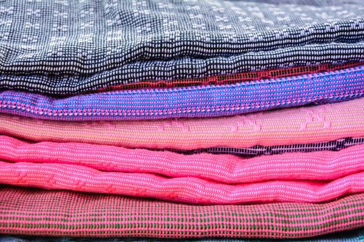 Stack of handmade woven fabrics in thailand 
