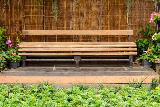 Wooden long bench in the garden 