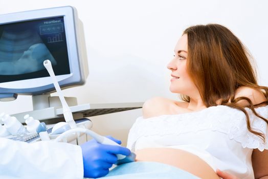 Young attractive pregnant woman on reception at the doctor, health check