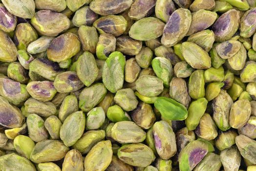 Close-up of roasted unshelled pistachios to use as background
