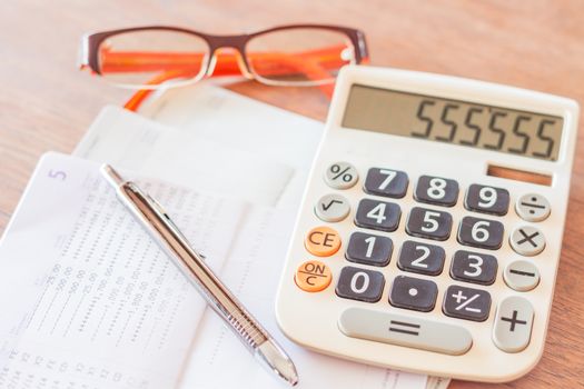 Work station with calculator, pen and eyeglasses, stock photo