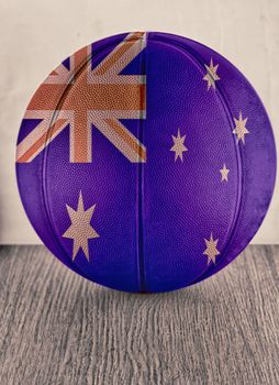 Basketball with flag of Australia, over wooden surface