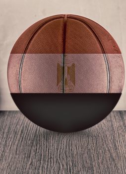 Basketball with flag of Egypt, over wooden surface, hdr image