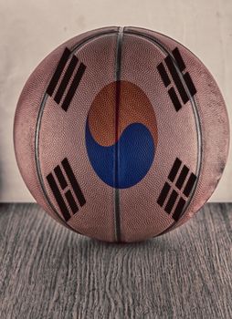 Basketball with flag of South Korea, over wooden surface