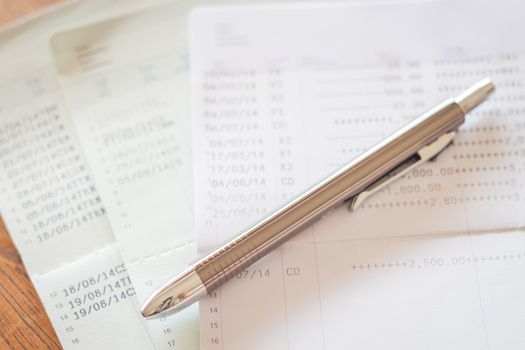 Three of bank account passbooks with pen, stock photo