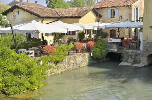 Restaurant next to the river Mincio in Borguetto, a ancient village  in the municipality of Valeggio, in the province of Verona; Italy.