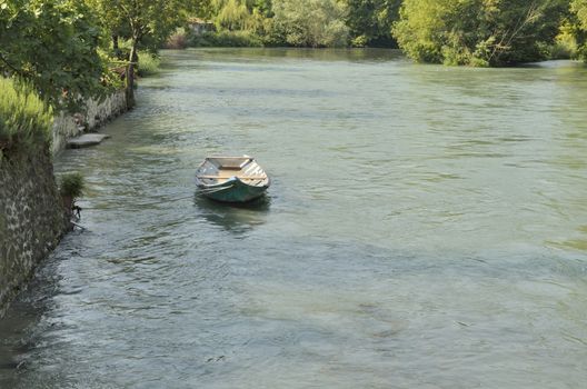 Boat in the river Mincio in Borguetto, a ancient village  in the municipality of Valeggio, in the province of Verona; Italy.