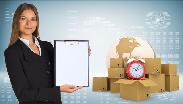 Businesswoman holding paper holder. Earth, alarm clock, cardboard boxes as backdrop