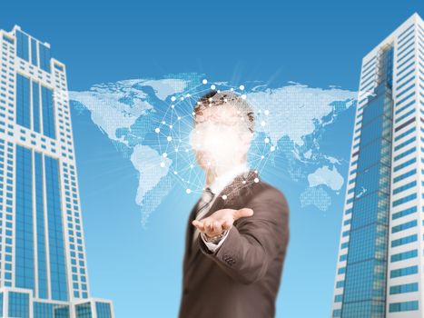 Skyscrapers. Businessman in a suit hold world map