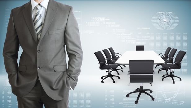 Businessman in suit. Conference table, chairs and laptops