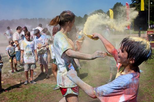 Lawrenceville, GA, USA - May 31, 2014:  A mother and son throw packets of colored corn starch on each other at Bubble Palooza.