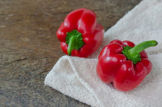 close up red bell peppers on wooden table