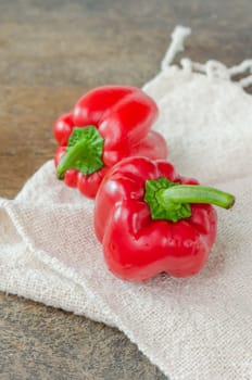 fresh two red bell peppers on wooden table