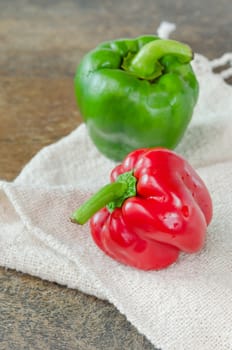 red and green bell peppers on wooden table