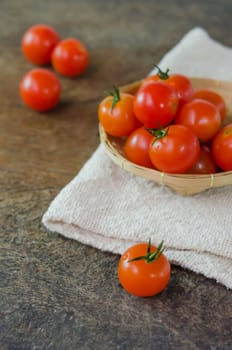Red ripe organic cherry tomatoes  with wooden basket