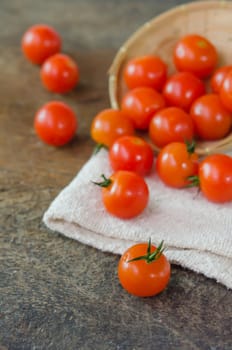 Red cherry tomatoes  spilling out from the basket