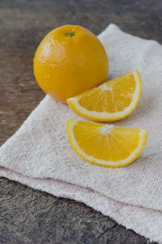 fresh  orange  fruits  and slices on wooden background